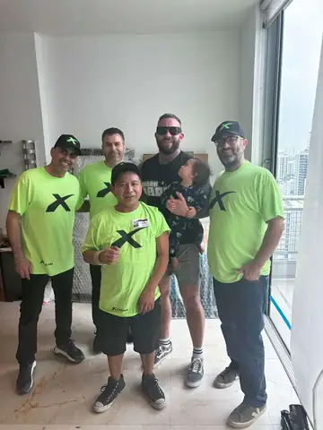 X Van Lines moving crew with a customer