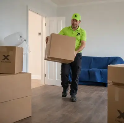 X Van Lines mover carrying a box